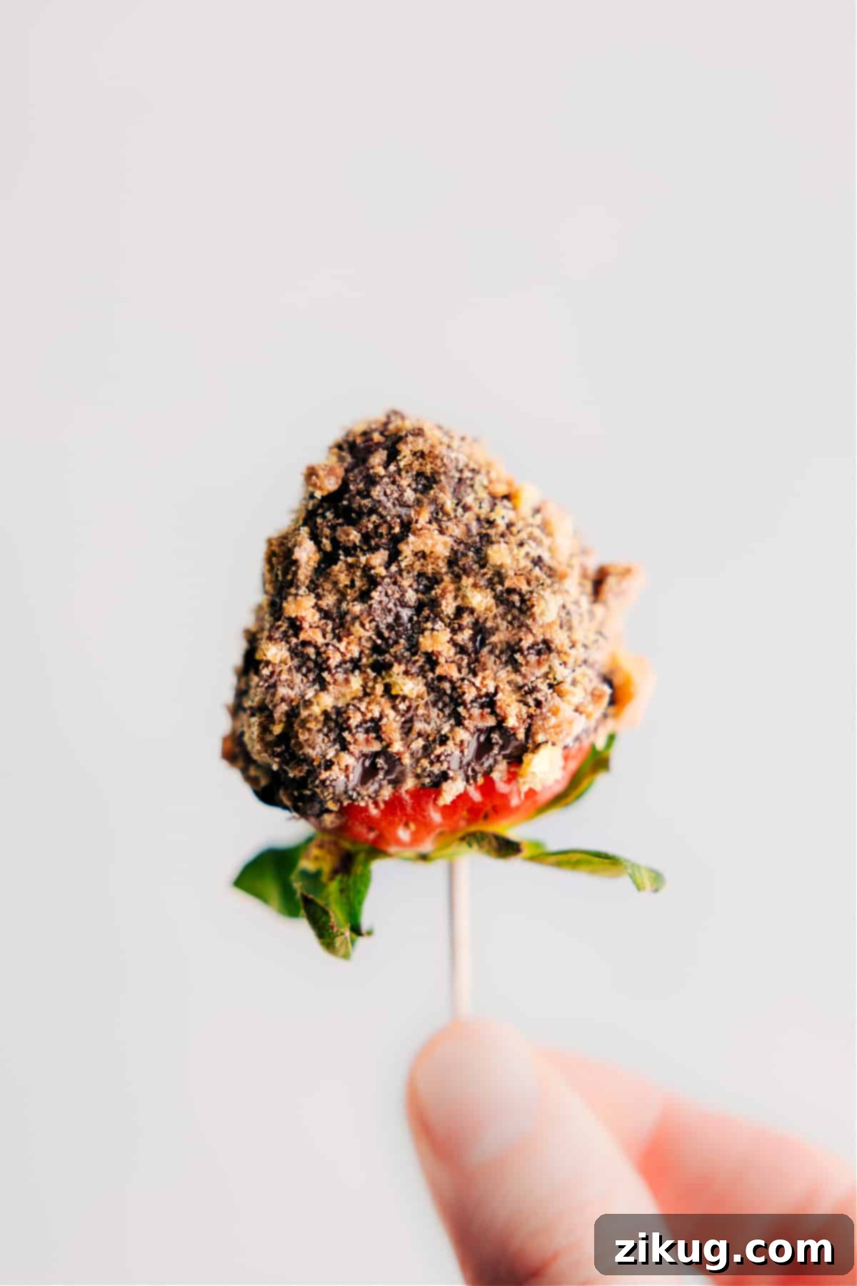 Dipped Strawberries: A sweet crunch in every bite. A close-up of a delectable chocolate-dipped strawberry, lavishly adorned with a generous coating of crunchy cookie crumbs, embodying a perfect balance of texture and flavor.