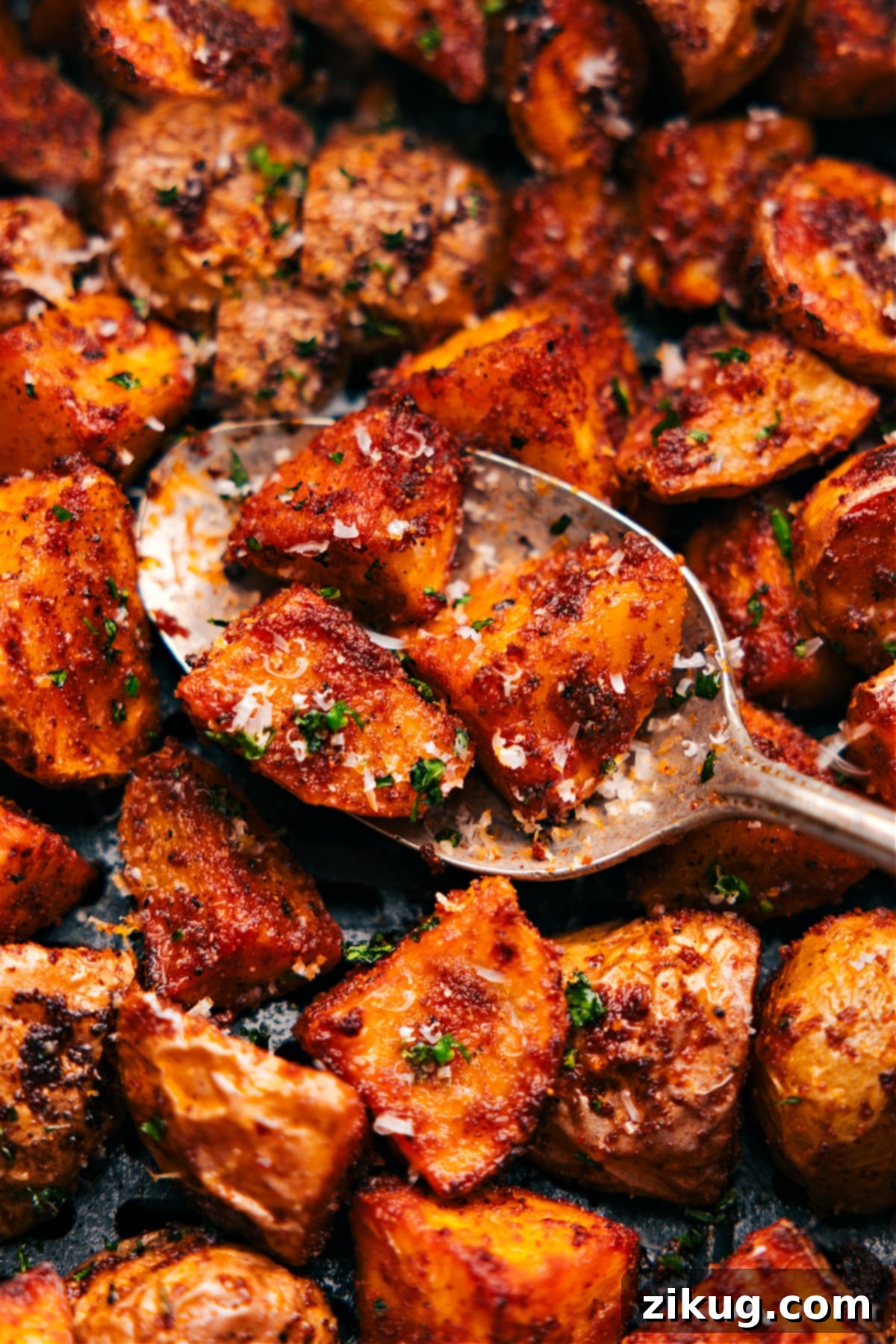Delectable Air Fryer Potatoes Up-close spoonful of the potatoes ready to be served, showing the tender interior.