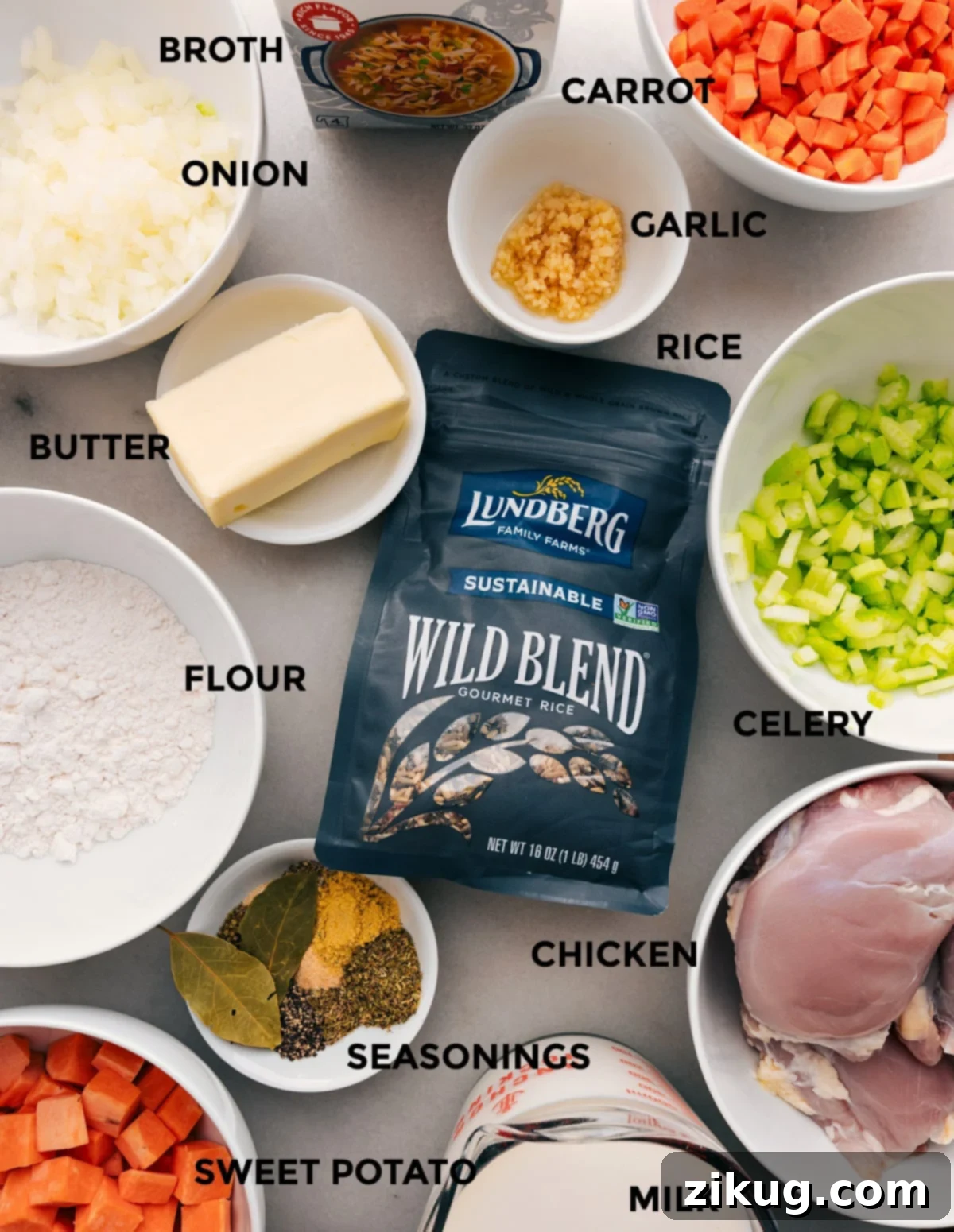 Ingredients In Crockpot Chicken And Wild Rice Soup A selection of fresh ingredients including chicken thighs, colorful vegetables, wild rice blend, and spices laid out for Crockpot Chicken Wild Rice Soup preparation.