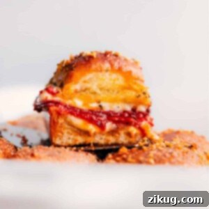 Delicious Pizza Sliders baked to perfection with melted cheese and pepperoni on Hawaiian rolls.