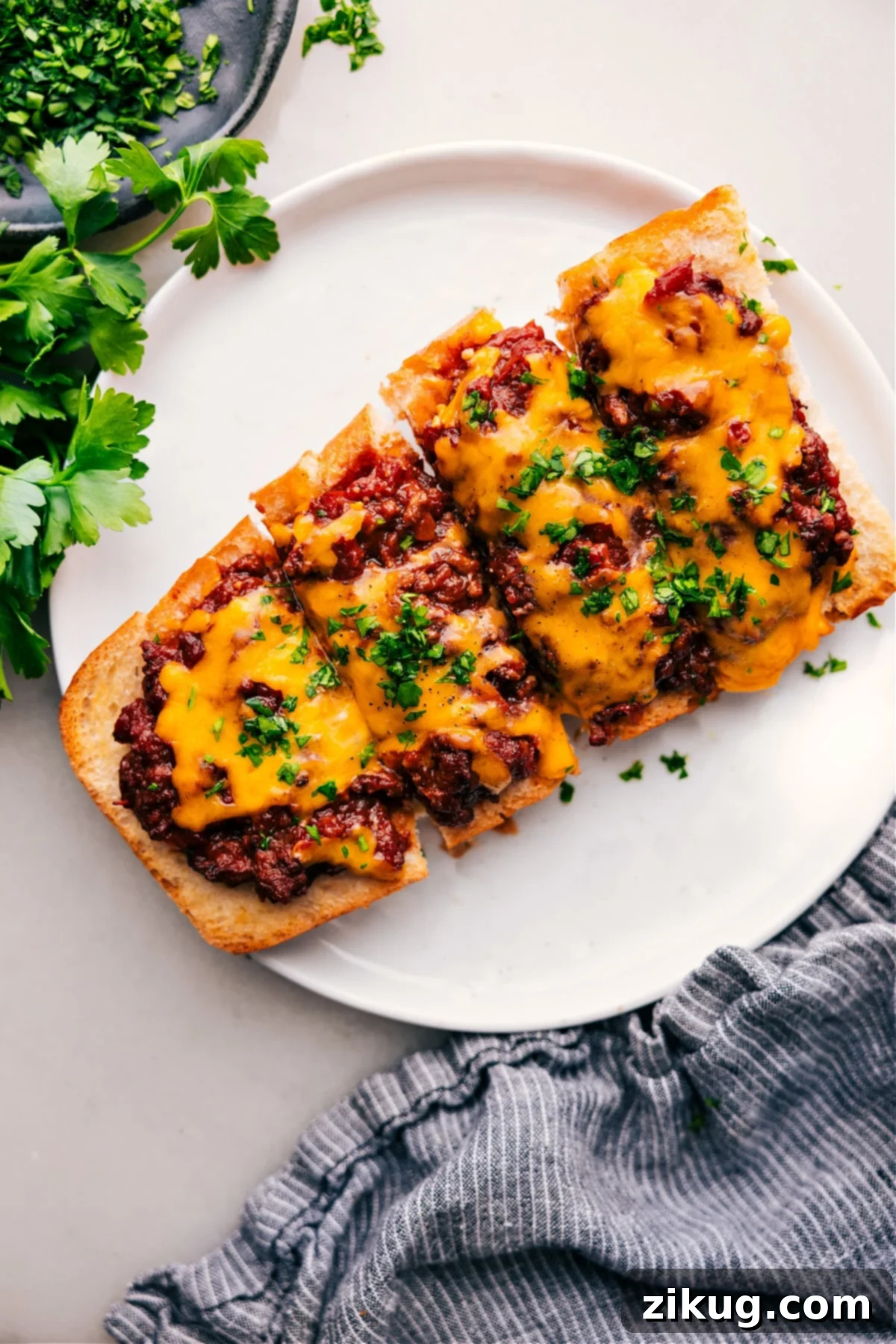 Irresistible Sloppy Joe Pizza A delicious Sloppy Joe Pizza slice on a white plate, showing melted cheese and savory meat topping.
