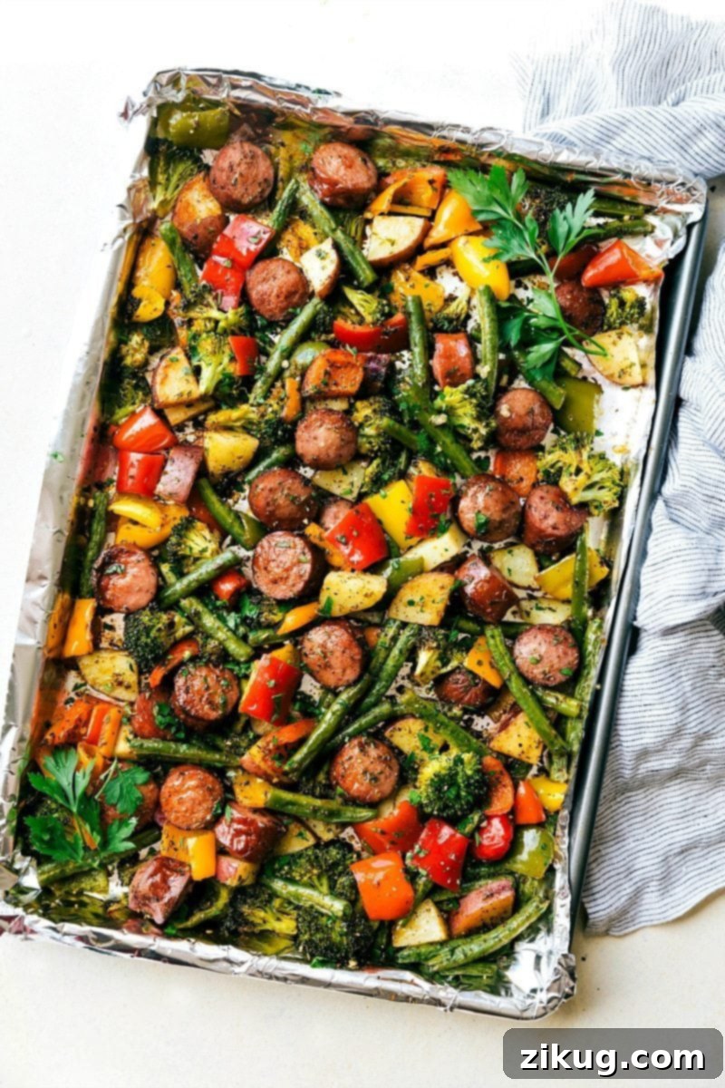 Perfectly Cooked Sheet Pan Sausage and Veggies, Ready to Serve The golden-brown sheet pan veggies and sausage, perfectly cooked on a foil-lined sheet pan, demonstrating ideal crispness and caramelization, ready to be served and savored.