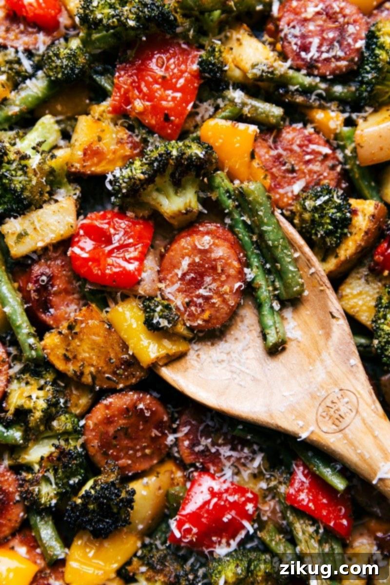 Ready-to-Serve Healthy and Delicious Meal A perfectly cooked, healthy, and delicious meal of sheet pan sausage and vegetables, artfully arranged and ready for immediate serving.
