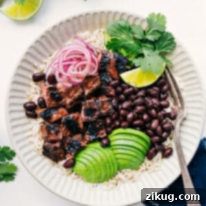 Hearty Steak Bowl 3 A vibrant Steak Bowl featuring grilled steak, cilantro-lime rice, black beans, avocado, and pickled onions.