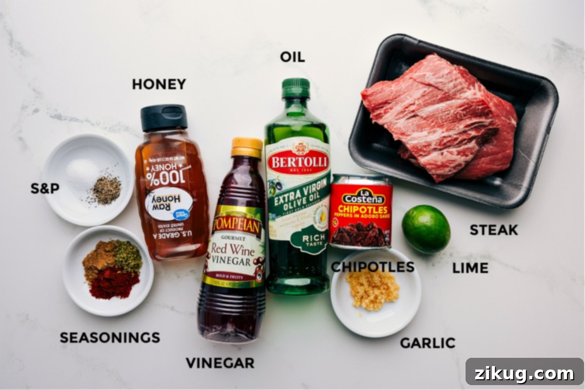 Ingredients In This Burrito Bowl Steak Marinade Marinade ingredients for a steak bowl, including spices, honey, vinegar, oil, chipotles, lime, and garlic, ready for blending.