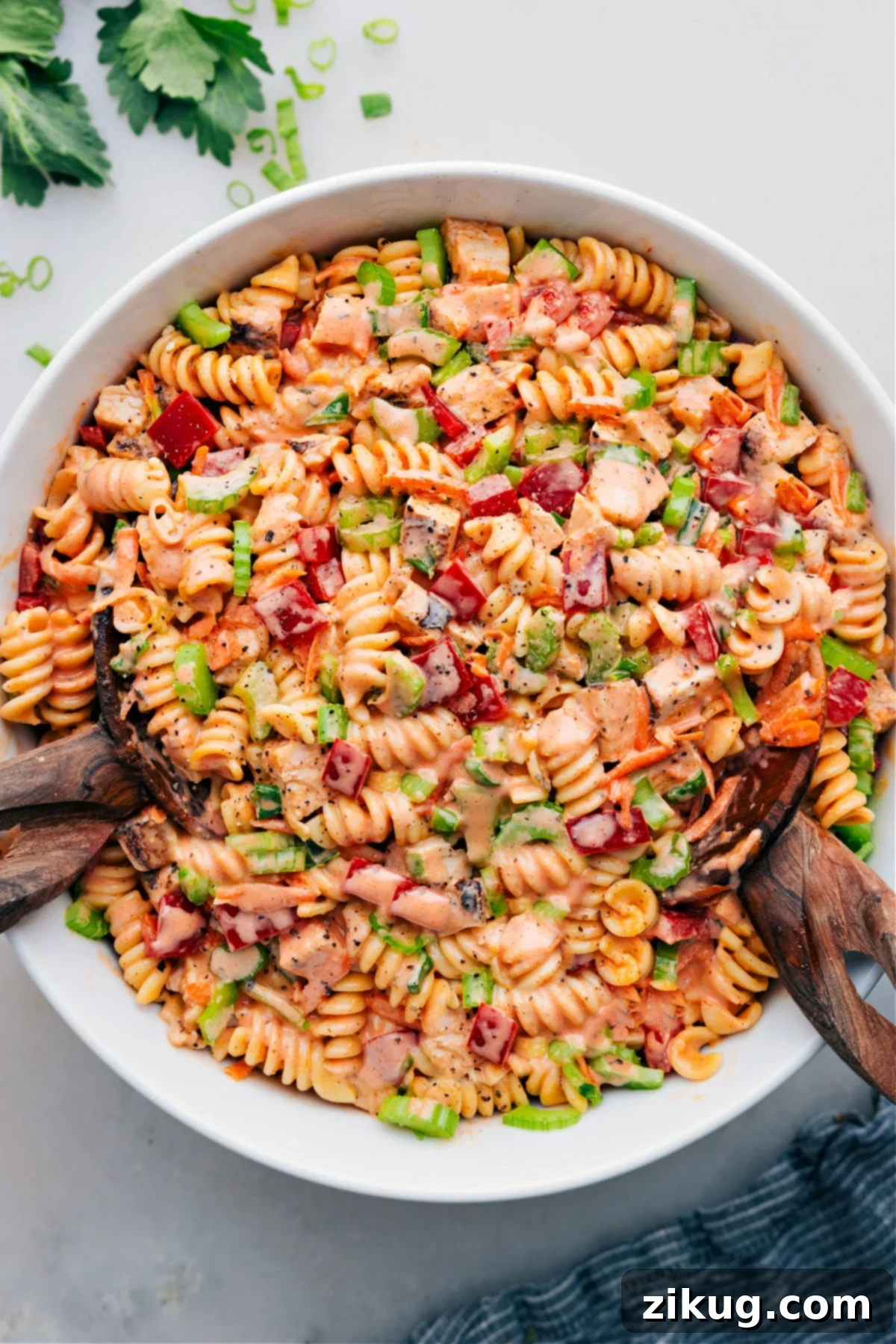Buffalo Chicken Pasta Salad: Spicy & Creamy Recipe Buffalo Chicken Pasta Salad in a large serving bowl, garnished with fresh herbs, ready to be enjoyed.