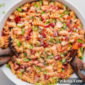 Potluck Perfect Buffalo Chicken Pasta Salad 3 Buffalo Chicken Pasta Salad in a bowl, showing the creamy dressing and colorful ingredients.
