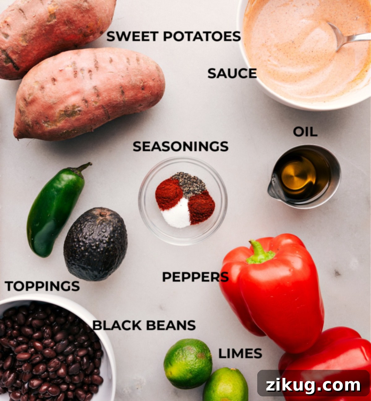 Prepped ingredients for flavorful Sweet Potato and Black Bean Burrito Bowls: Ready to Assemble A vibrant selection of prepped ingredients for Sweet Potato and Black Bean Burrito Bowls, including neatly diced sweet potatoes, rinsed black beans, freshly sliced red bell peppers, creamy halved avocado, sliced jalapeños, and bright lime wedges, alongside a bowl of the creamy dressing.