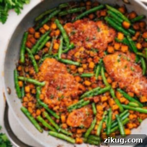 A delicious skillet meal featuring crispy chicken pieces and caramelized butternut squash.