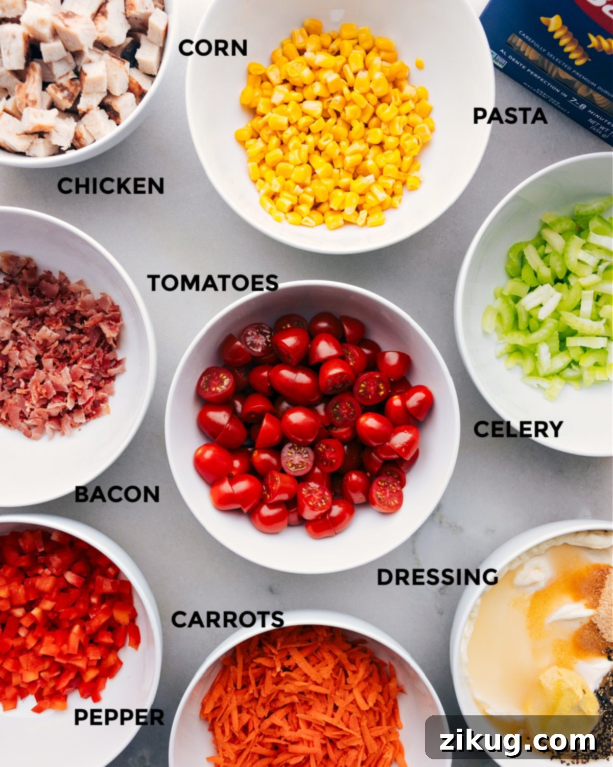 Ingredients In Chicken Pasta Salad All the fresh and prepared ingredients for the chicken pasta salad laid out on a table for easy assembly.