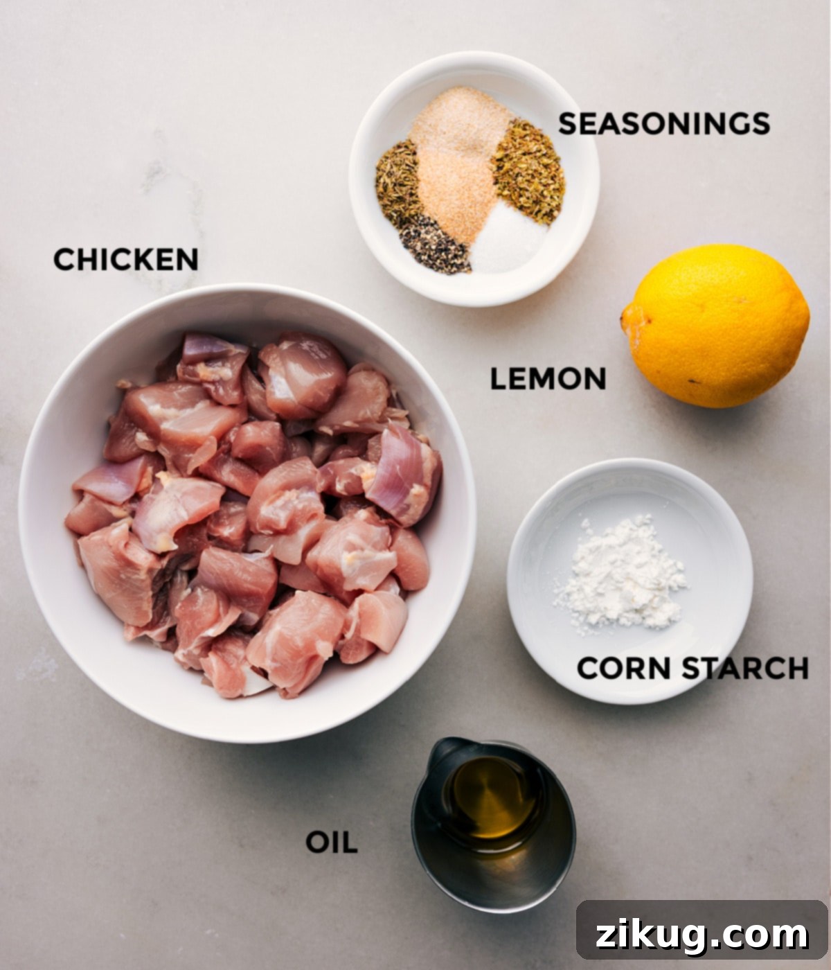 Key Ingredients for Authentic Greek Chicken Bowls All the fresh ingredients for Greek Chicken Bowls, meticulously prepped and laid out for easy assembly, highlighting vibrant vegetables, seasoned chicken, and creamy tzatziki.