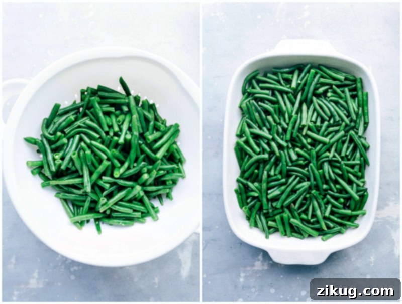 Vibrant fresh green beans being carefully arranged in a white ceramic casserole dish, ready for the creamy sauce to be poured over for the homemade green bean casserole recipe.