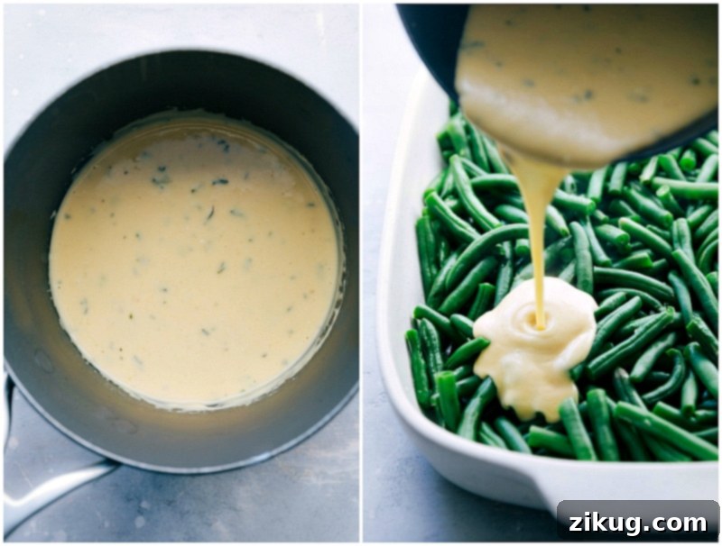 Velvety cream sauce being poured generously over blanched green beans in a white casserole dish, showing the luxurious consistency of the homemade sauce.
