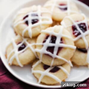 Sweet Jam Impressions 2 A plate of freshly baked Raspberry Thumbprint Cookies with a drizzle of white glaze.