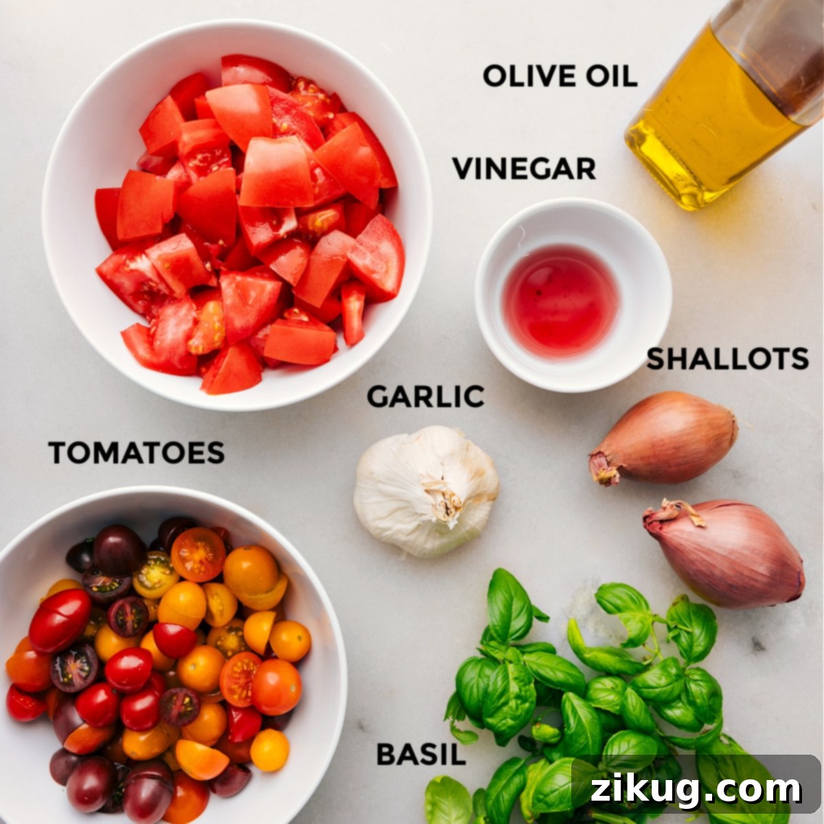 Carefully arranged fresh ingredients for a tomato salad, including various types of tomatoes, basil, and seasonings.