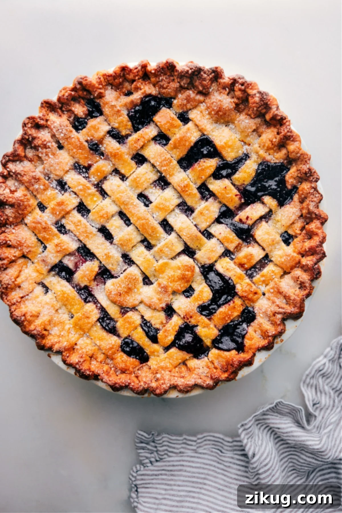 Freshly baked berry pie made with the best pie crust recipe, ready to be served, showcasing a golden, flaky crust.