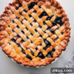 Freshly baked berry pie made with the best pie crust recipe, ready to be served, highlighting the perfect golden-brown crust.