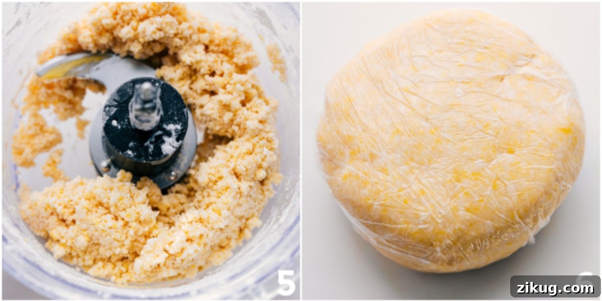 Thick, chilled pie dough meticulously rolled out from the food processor onto plastic wrap, showcasing its smooth texture and even thickness, ready to be pressed into the pie pan.