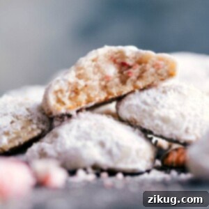 Melt-in-Your-Mouth Peppermint Snowballs 2 Delicious and seasonal desserts stacked on top of each other, with a bite out of one revealing the moist and flavor-packed interior.