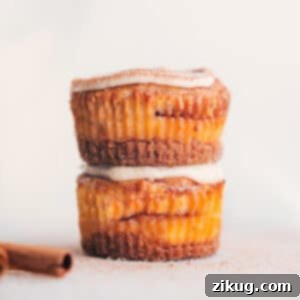 Delicious Cinnamon Roll Cheesecakes topped with a swirl of cream cheese frosting.