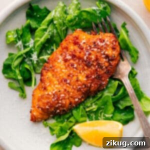 A close-up of a golden brown crispy chicken cutlet, perfectly pan-fried and ready to be served.