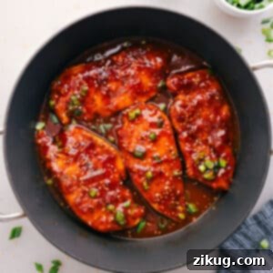 Sticky Honey Garlic Chicken 2 Honey Garlic Chicken cooked in a skillet, topped with green onions and sesame seeds.