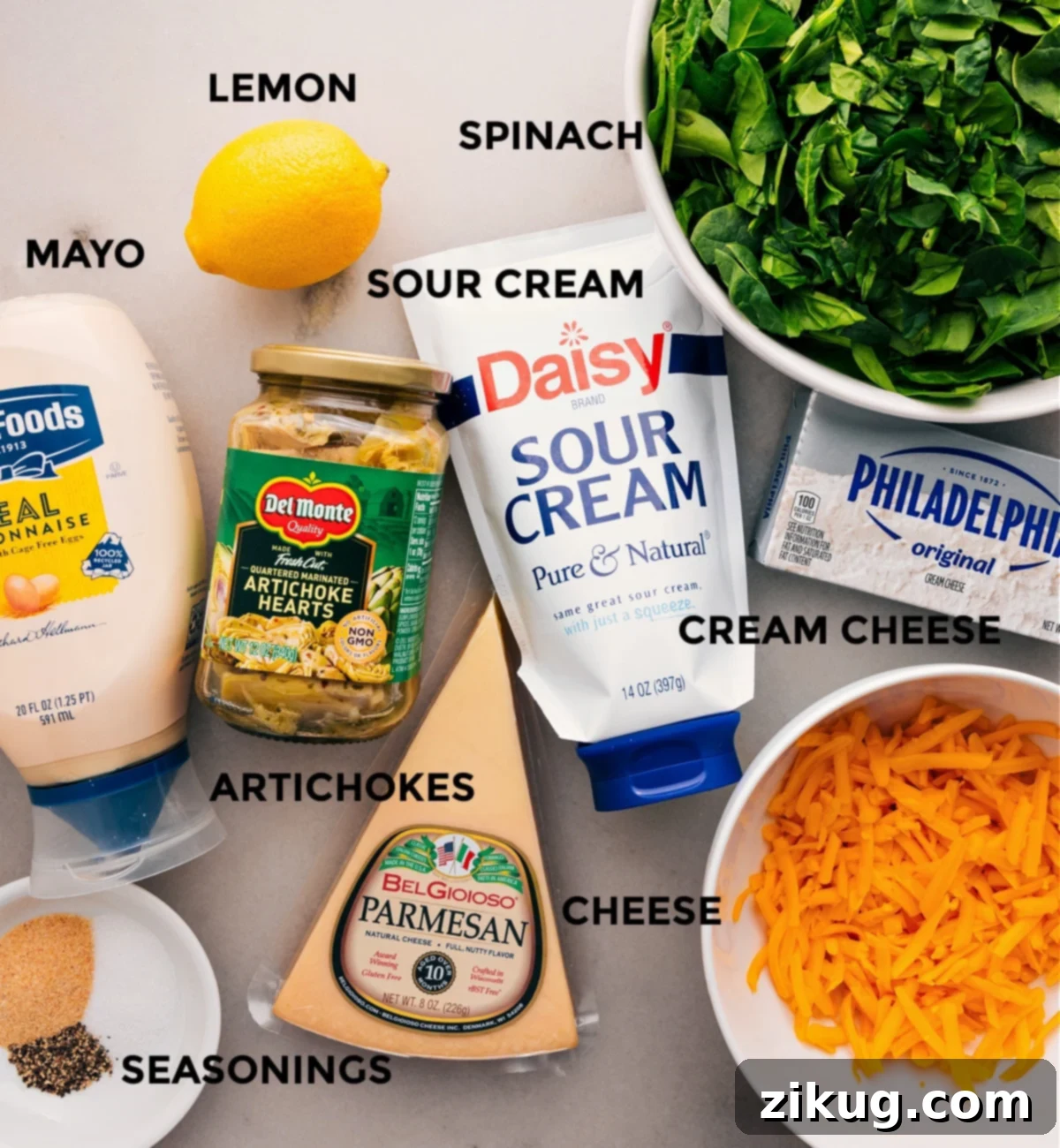 Ingredients In Spinach Artichoke Dip All the fresh and creamy ingredients for a homemade Spinach Artichoke Dip are meticulously prepped and laid out for effortless assembly: vibrant spinach, tangy lemon, rich cream cheese, smooth mayo, sour cream, sharp cheddar, savory artichokes, and aromatic seasonings.