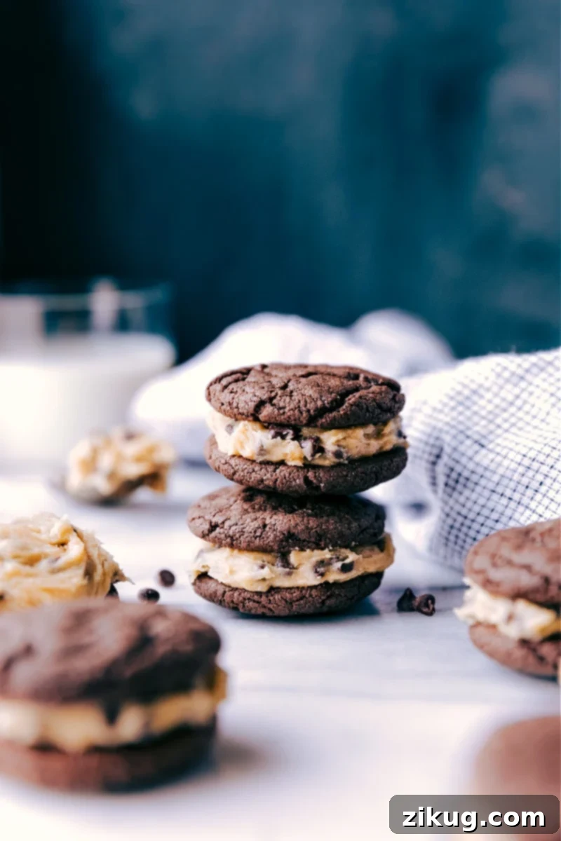 Homemade Cookie Dough Oreos stacked on top of each other, showcasing their rich chocolate cookies and creamy cookie dough filling.