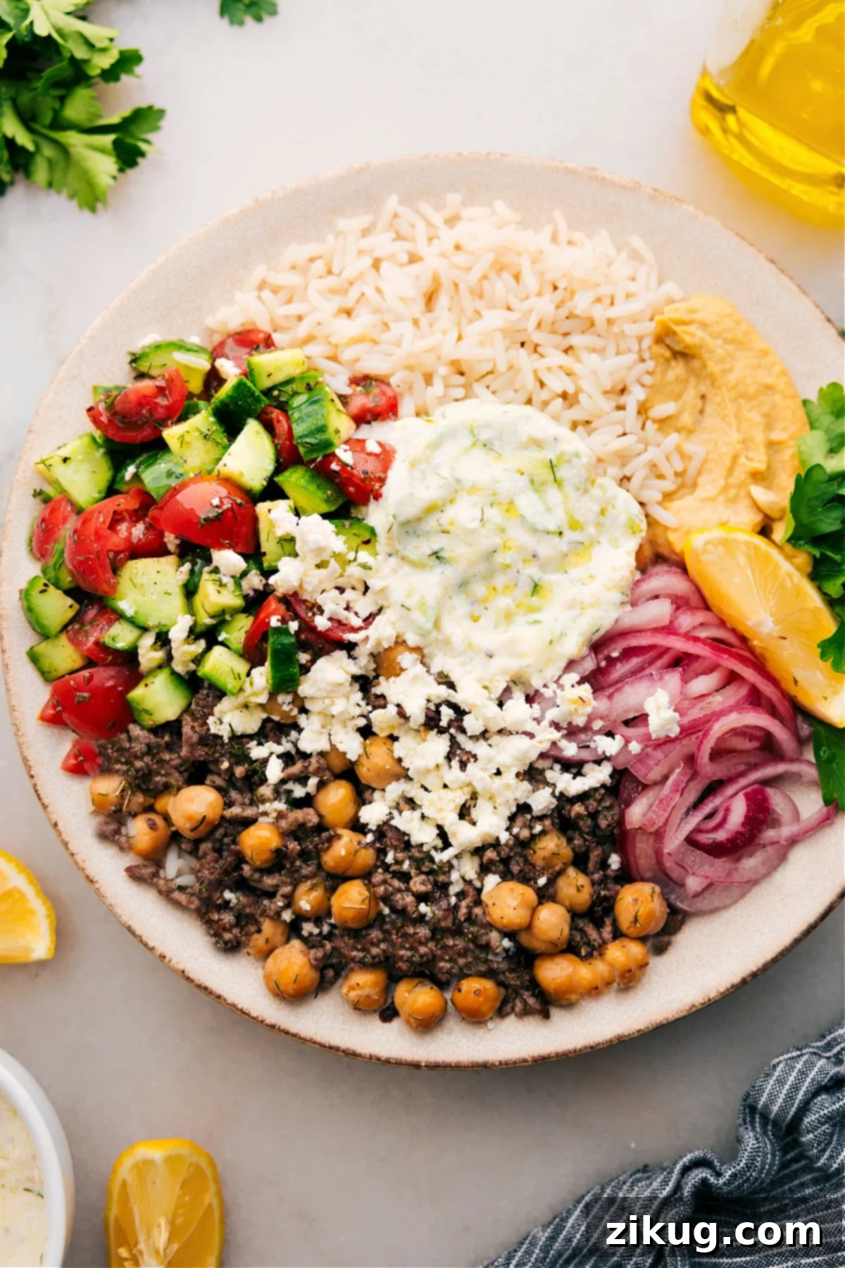 The Best Greek Beef Bowl Recipe To Meal Prep And Enjoy The completed Greek Beef Bowl is beautifully presented in a rustic ceramic bowl, ready to be served and savored, showcasing its layers of flavorful beef, fresh vegetables, and creamy sauces.