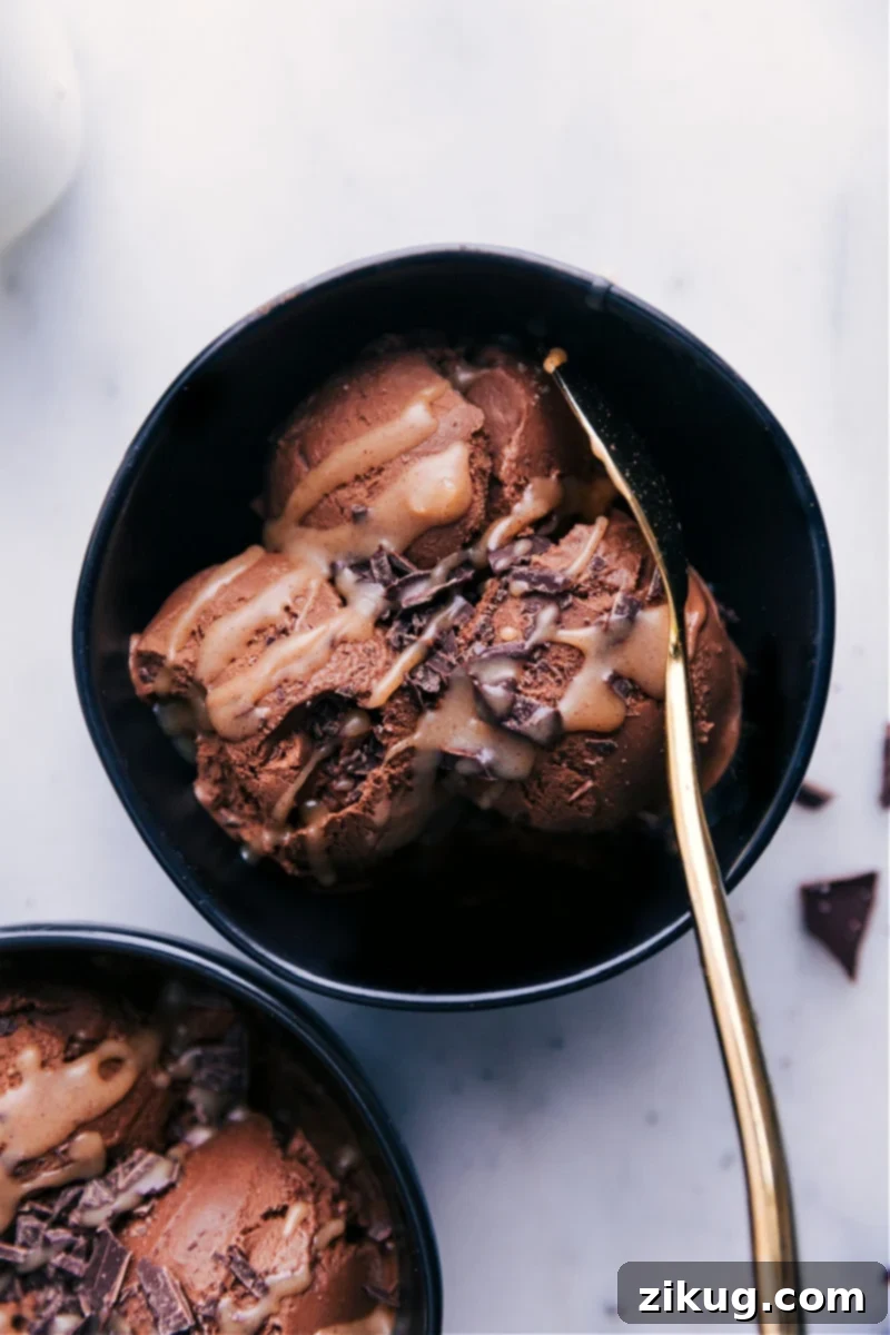 Guilt-Free Frozen Delights 2 A scoop of healthy chocolate ice cream in a bowl, topped with caramel and chocolate shavings.