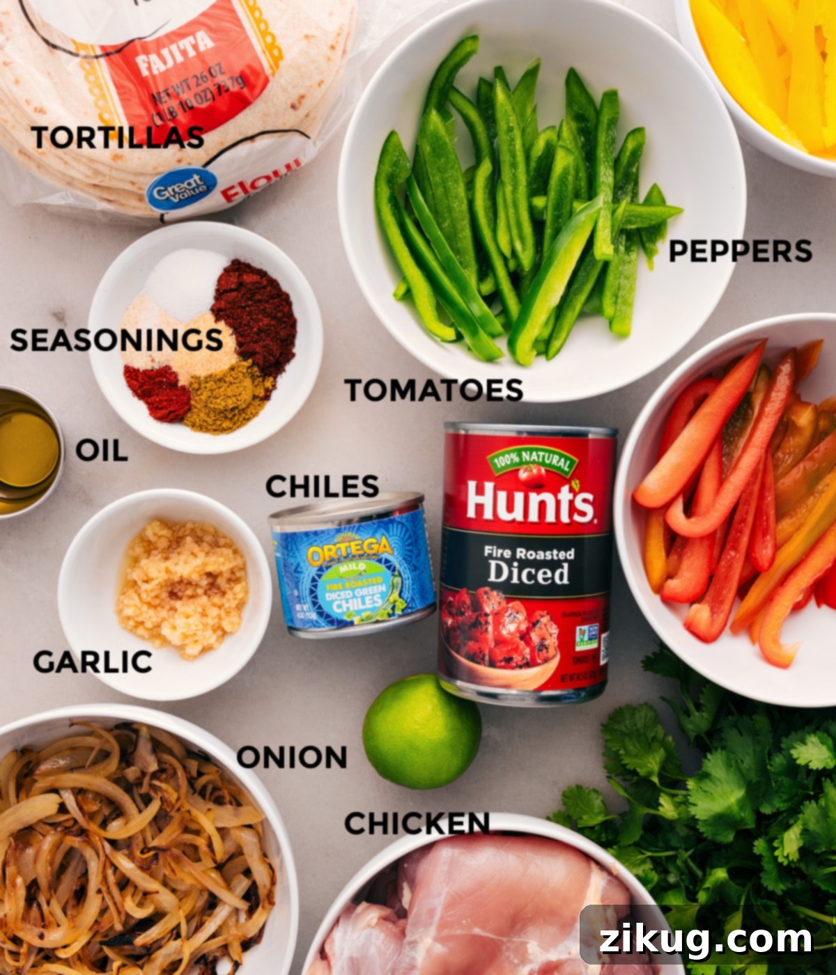Effortless Slow Cooker Fajita Fiesta 2 All fresh ingredients for Crockpot Chicken Fajitas prepped on a counter: colorful bell peppers, chicken, diced tomatoes, chiles, garlic, seasonings, tortillas, onions, and limes.