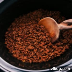 Cooked crockpot taco meat, ready for serving in a recipe card thumbnail.
