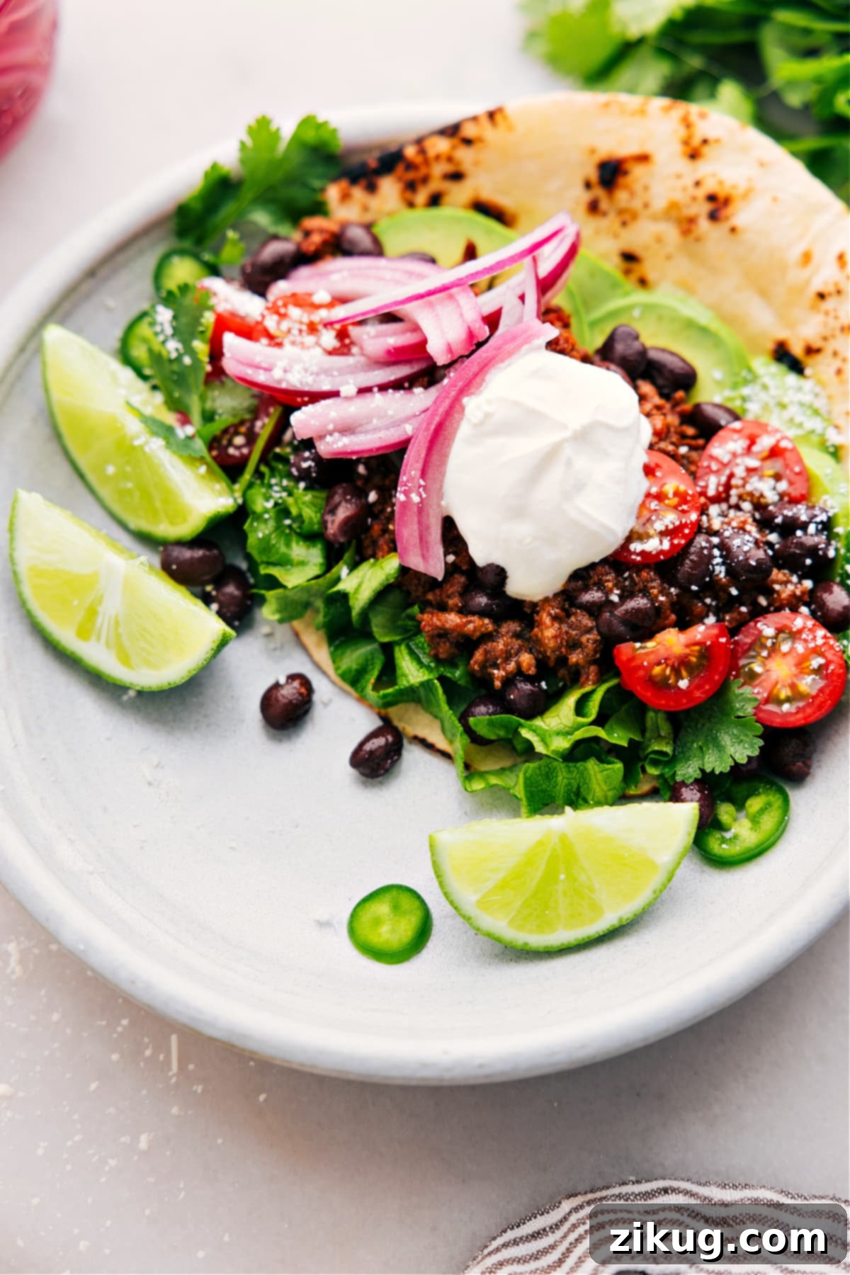 Add Your Crockpot Taco Meat Into A Tasty Taco A freshly assembled taco filled with delicious slow-cooked ground beef from the crockpot, ready to be enjoyed.