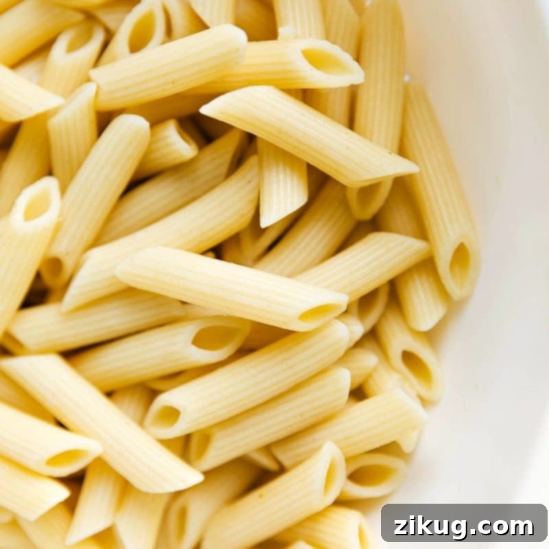 Crimson and Cream Pasta 2 Cooked penne noodles prepared and ready to be combined with the flavorful sauce.