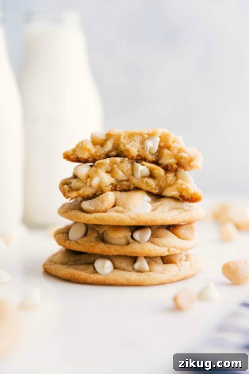 White Chocolate Macadamia Nut Cookies: The Best Homemade Recipe White Chocolate Macadamia Nut Cookies stacked with one broken in half, showcasing their perfect texture.
