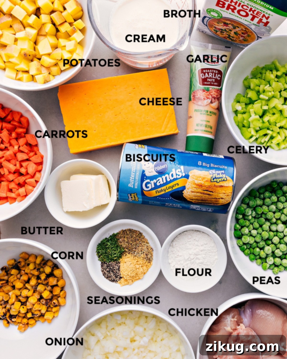 Key Ingredients for Delicious Crockpot Chicken Pot Pie All the fresh ingredients for Crockpot Chicken Pot Pie are prepped and laid out for easy assembly, including diced carrots, celery, onions, potatoes, chicken thighs, butter, broth, cream, cheese, and biscuits.