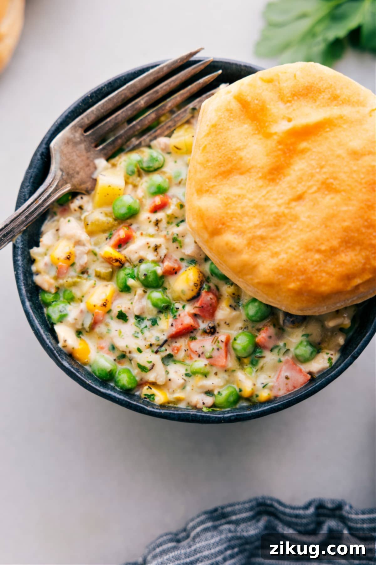 A Delicious and Easy Weeknight Dinner: Crockpot Chicken Pot Pie A close-up of the Crockpot Chicken Pot Pie in the slow cooker, showing the creamy chicken and vegetable filling with melted cheese sprinkled on top, ready to be served.