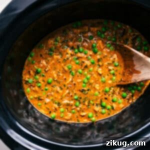 Finished Crockpot Curry Chicken served with rice.