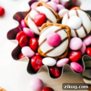 Sweet & Simple: 4 Valentine's Day Delights 4 Close-up of a Heart Hug Pretzel featuring a square pretzel, a melted chocolate Hershey's Hug, and a pink M&M in the center. The soft focus highlights the appealing texture and vibrant colors of this easy Valentine's Day treat.