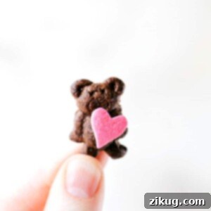 Sweet & Simple: 4 Valentine's Day Delights 10 Close-up of a Mini Valentine's Bear, a Teddy Graham cracker holding a small red heart sprinkle. The focus is on the sweet detail, making it an appealing image for an easy, kid-friendly Valentine's Day treat.