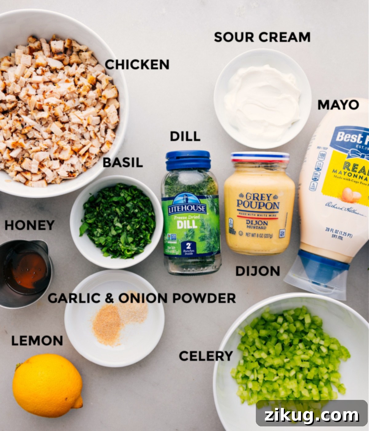 Key Ingredients for Lemon Basil Chicken Salad All the fresh ingredients required for this Lemon Basil Chicken Salad recipe are neatly prepped and laid out for easy assembly, including chicken, mayonnaise, sour cream, Dijon mustard, fresh herbs, celery, lemon, and honey.