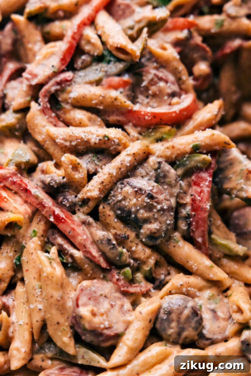 Comforting And Delicious Cajun Sausage Pasta Creamy Cajun Sausage Pasta in a pot, ready to serve.