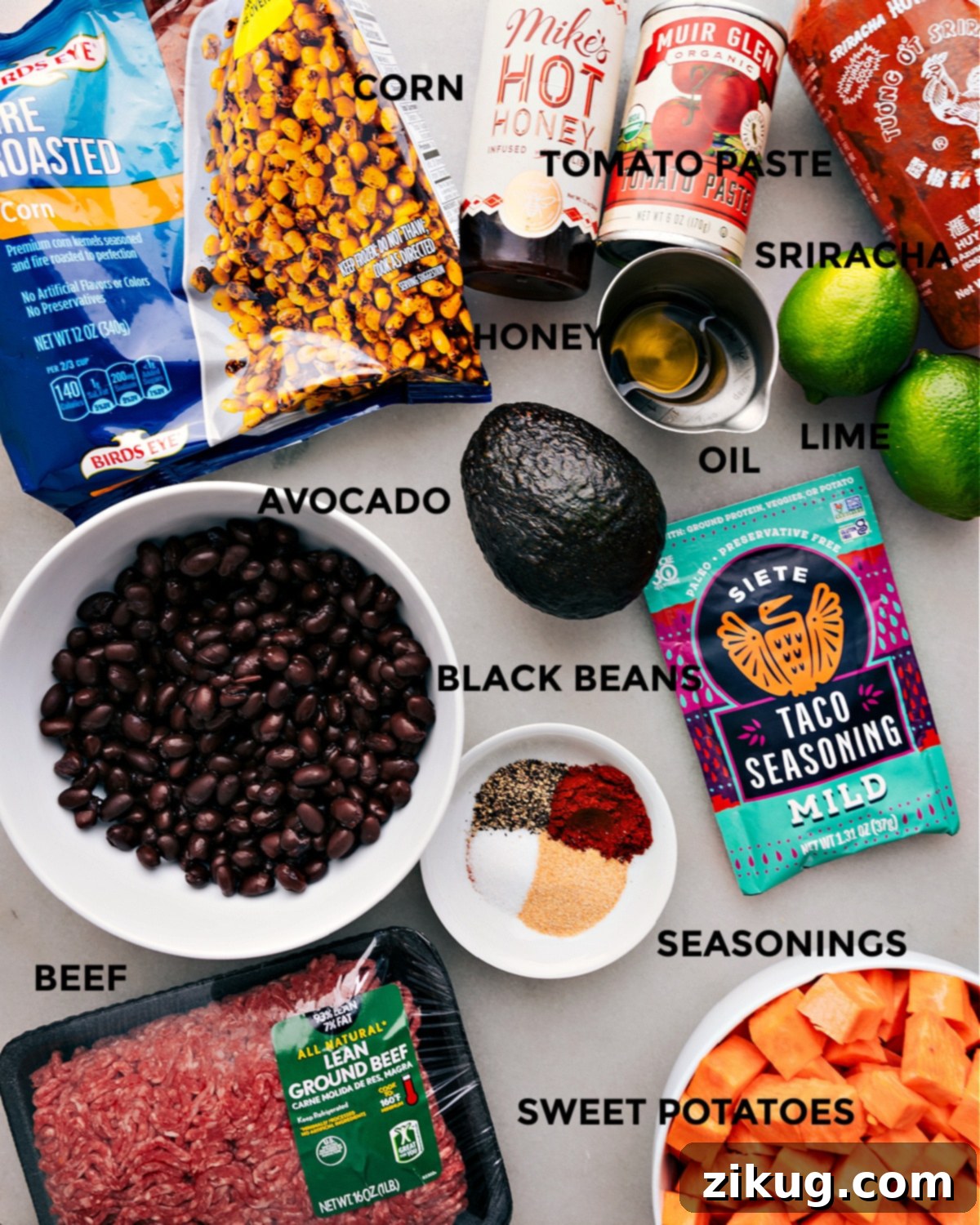 Fresh Ingredients for a Delicious Ground Beef Taco Bowl A top-down view of all prepped ingredients for the Ground Beef Taco Bowl including diced sweet potatoes, corn, black beans, ground beef, avocado, lime, hot honey, and various seasonings, ready for cooking and assembly.