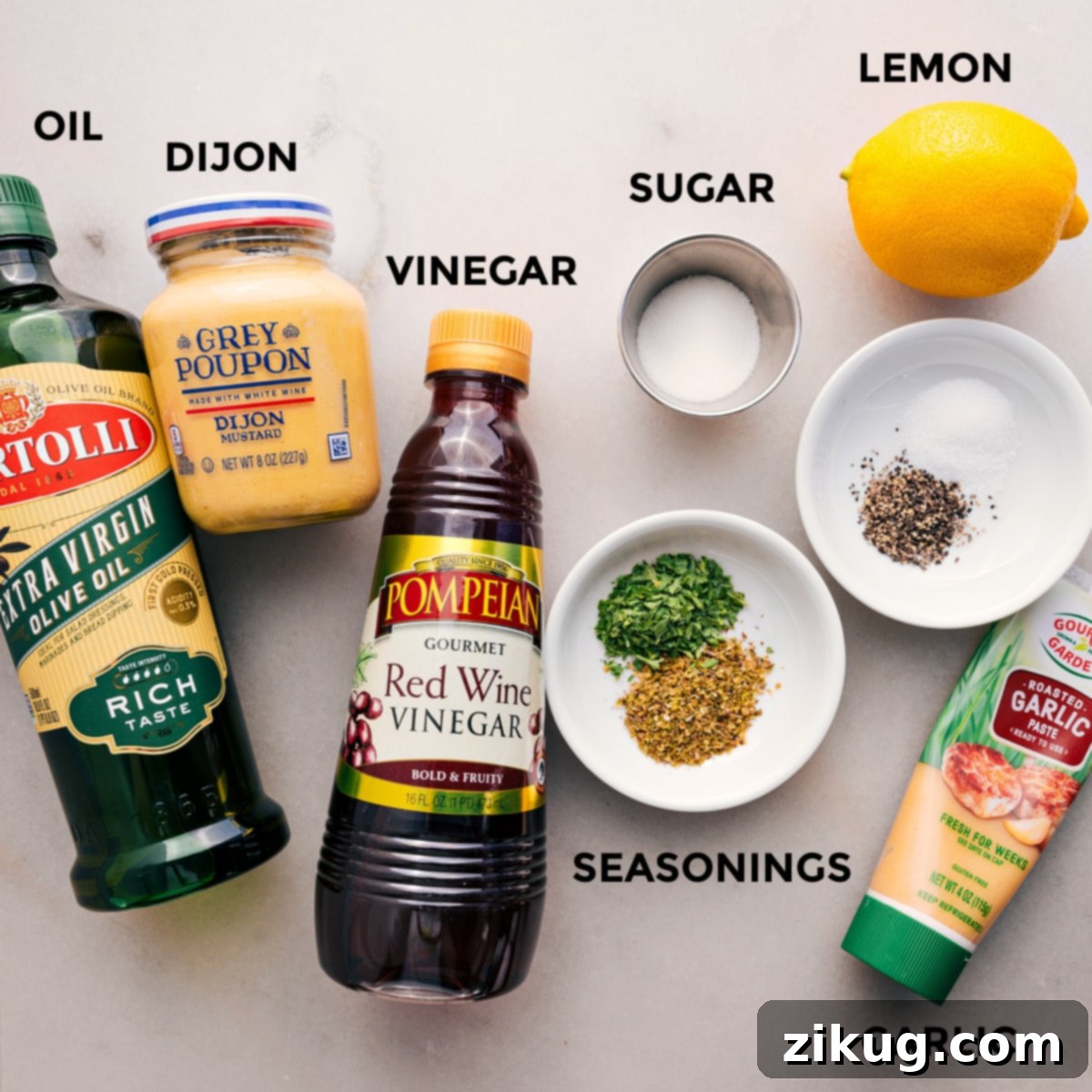 All the dressing ingredients for the dense bean salad are prepped and ready for easy assembly: olive oil, Dijon mustard, red wine vinegar, sugar, dried seasonings, minced garlic, and fresh lemon slices.