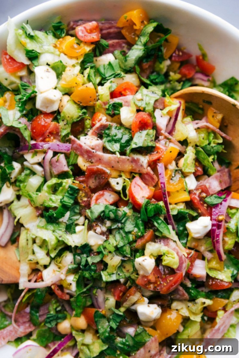 Refreshing Chopped Italian Salad, Dressed and Table-Ready Chopped Italian salad, fresh and dressed, ready to be enjoyed on a serving plate.
