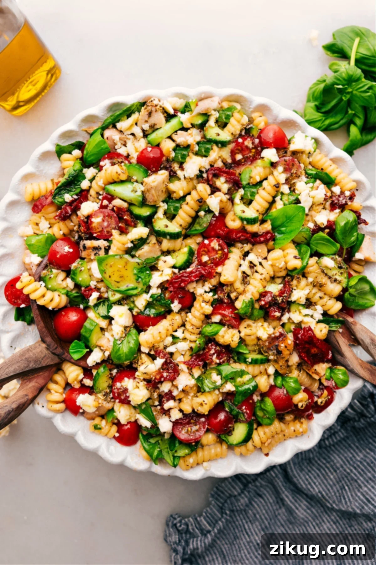 Irresistible Marry Me Chicken Pasta Salad Recipe A serving of Marry Me Chicken Pasta Salad in a bowl, garnished with fresh basil, ready to be enjoyed.