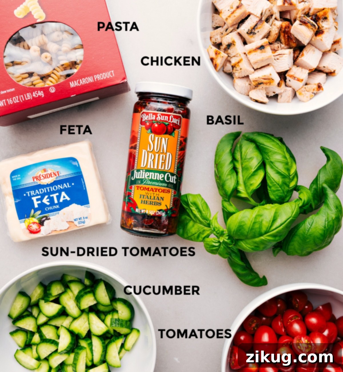 Essential Ingredients for Marry Me Chicken Pasta Salad All the fresh ingredients laid out for Marry Me Chicken Pasta Salad: cooked pasta, diced chicken, vibrant basil, crumbled feta, sun-dried tomatoes, crisp cucumber, and halved cherry tomatoes.