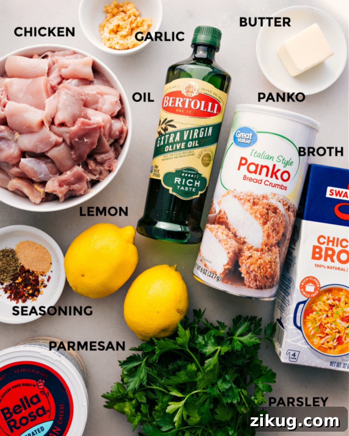 All the fresh ingredients for Chicken Spiedini are neatly arranged and prepped, including chicken, olive oil, Panko, butter, garlic, broth, lemon, seasonings, Parmesan, and parsley, ready for easy assembly.