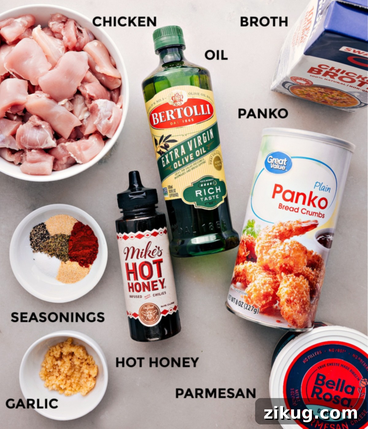 Ingredients In Hot Honey Chicken All the fresh ingredients laid out for making hot honey chicken: chicken, olive oil, chicken broth, minced garlic, spices, panko, parmesan, butter, hot honey, and hot sauce.