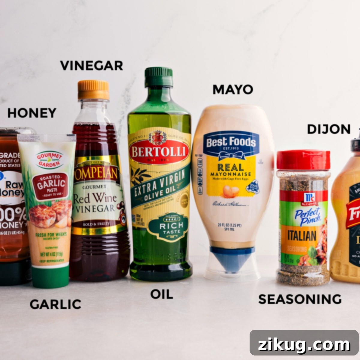 The Best Dressing For Italian Grinder Pasta Salad A collection of ingredients for the Italian Grinder Pasta Salad dressing, including olive oil, red wine vinegar, mayonnaise, minced garlic, Dijon mustard, honey, and Italian seasoning.